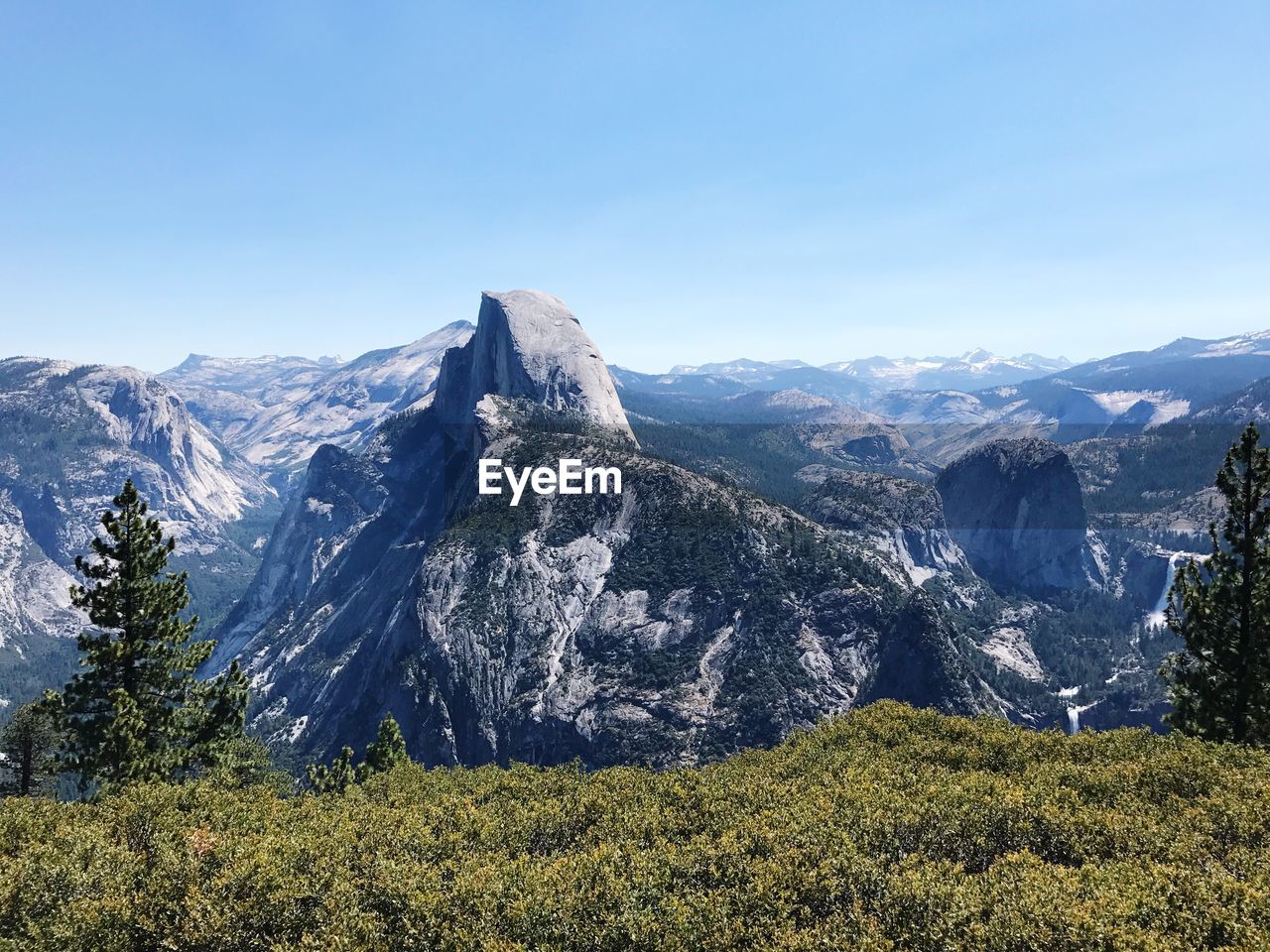 Scenic view of mountains against clear blue sky