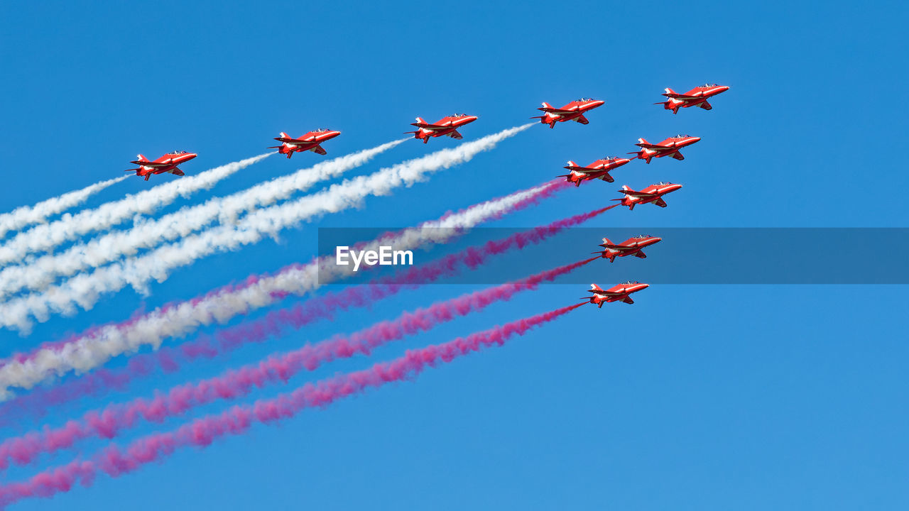 low angle view of kites flying against clear sky