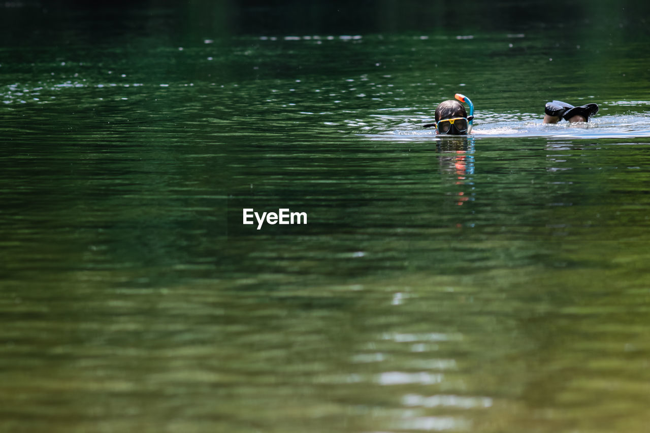 Person swimming in lake