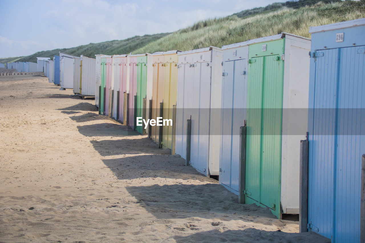 Row of beach huts against sky