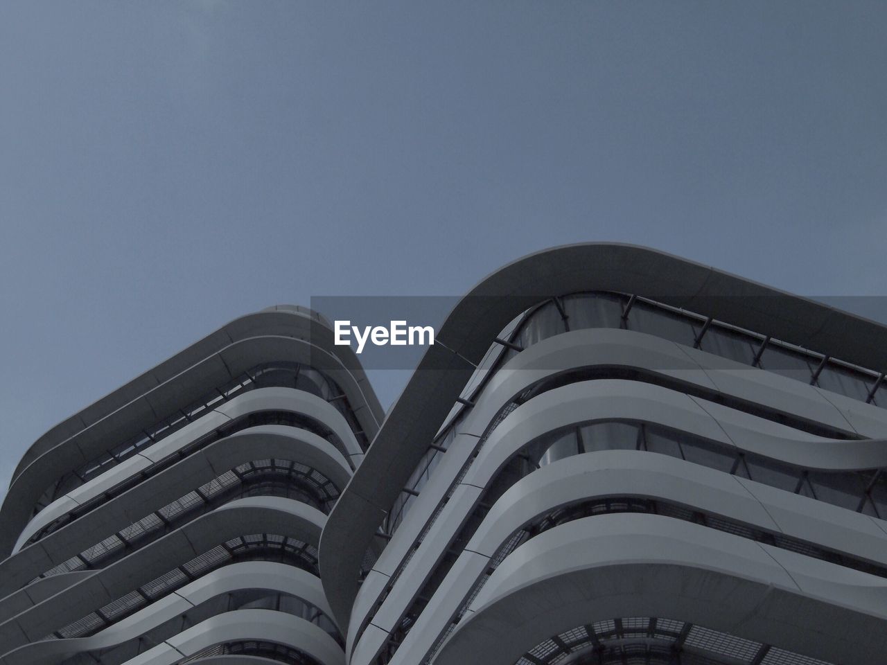 LOW ANGLE VIEW OF OFFICE BUILDING AGAINST SKY