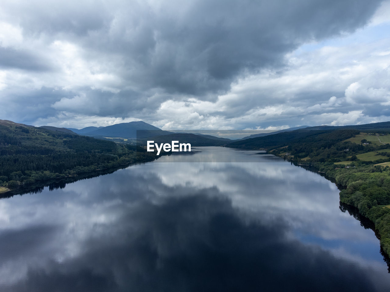 SCENIC VIEW OF MOUNTAINS AGAINST CLOUDY SKY