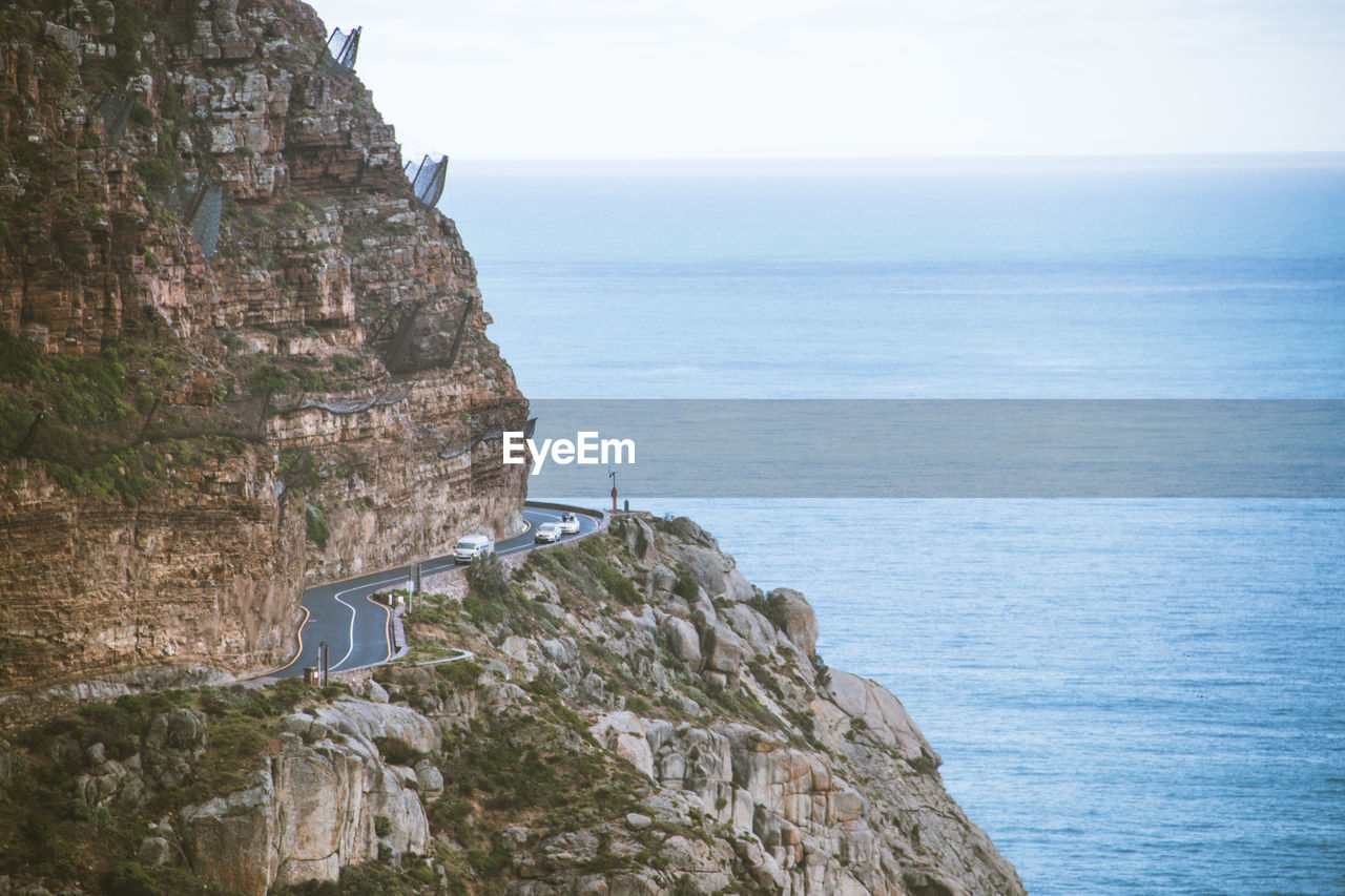 SCENIC VIEW OF SEA AND CLIFF AGAINST SKY