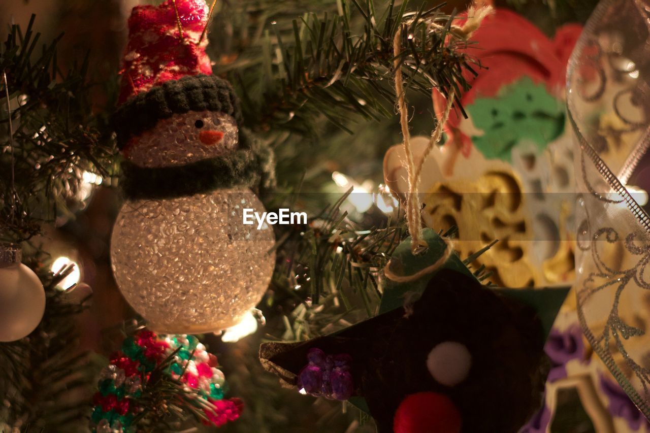 Close-up of ornaments hanging on christmas tree