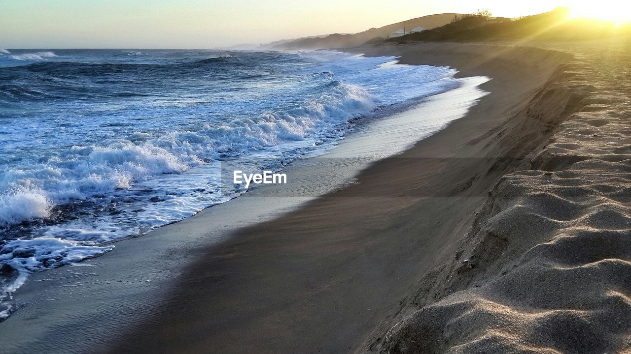 Sunrise over sandy beach