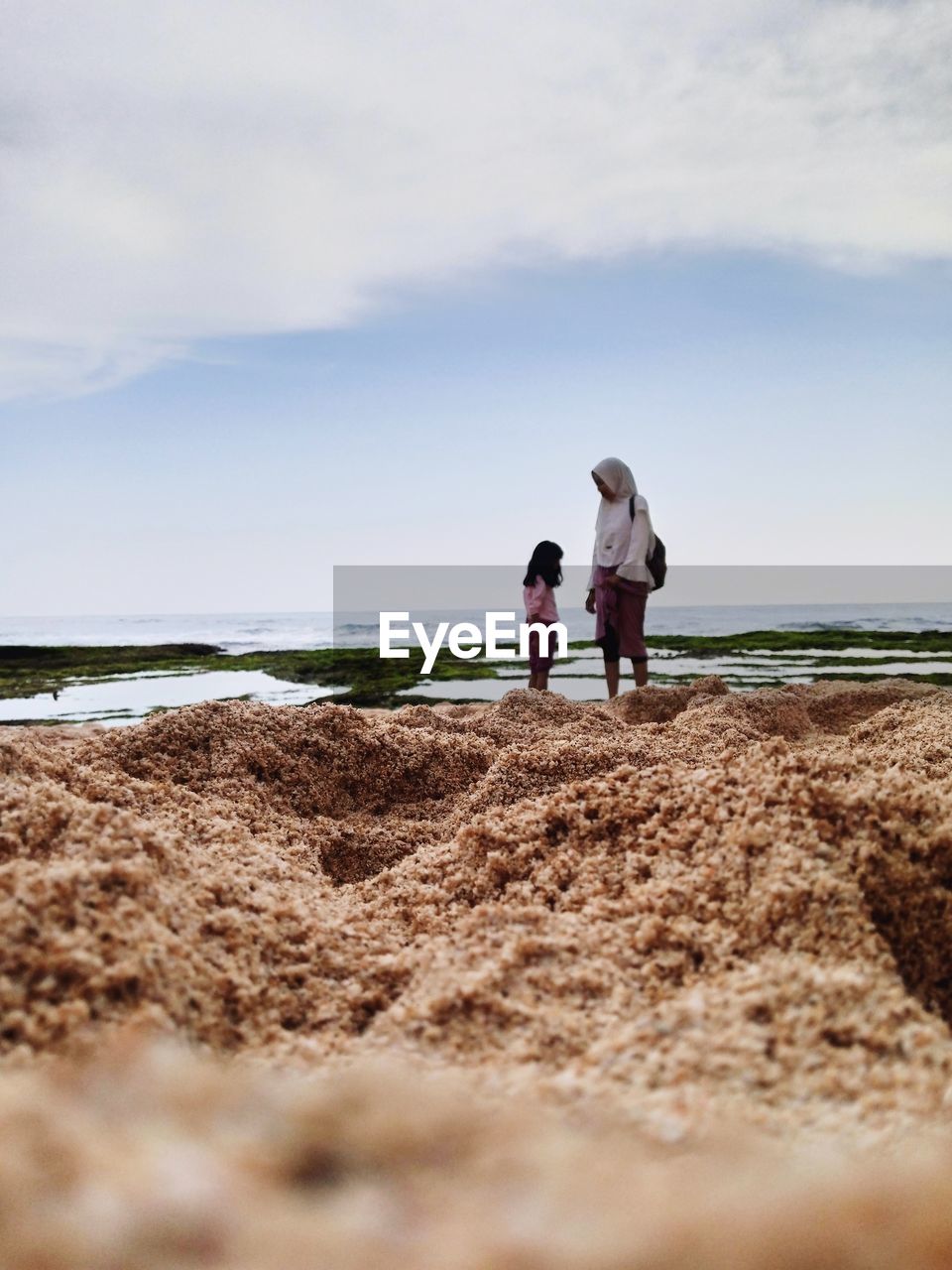 rear view of woman walking at beach