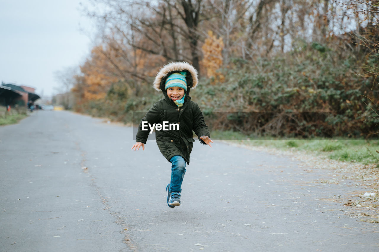 Young boy running towards camera