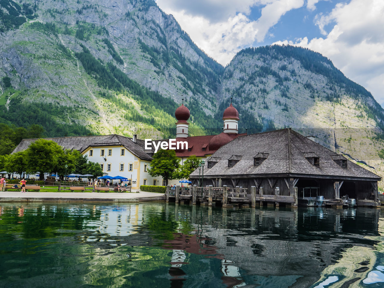 Houses by lake against mountains