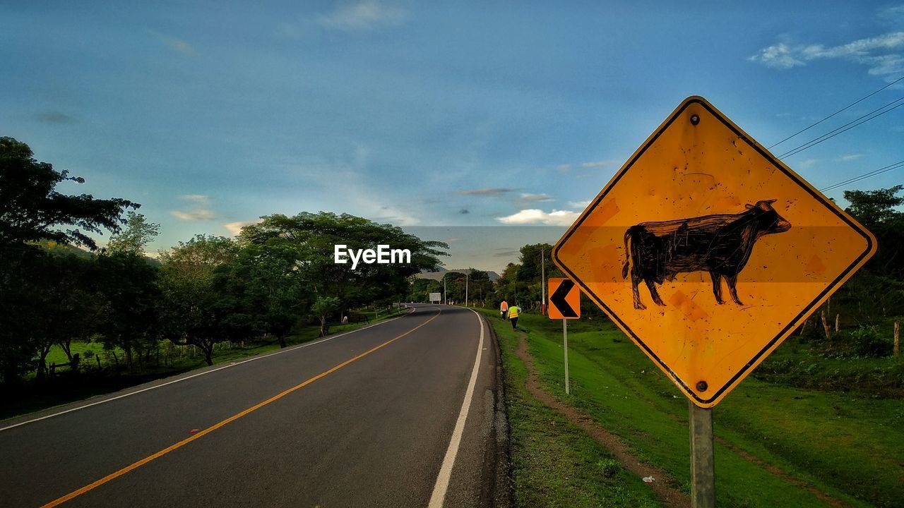 Road sign against sky