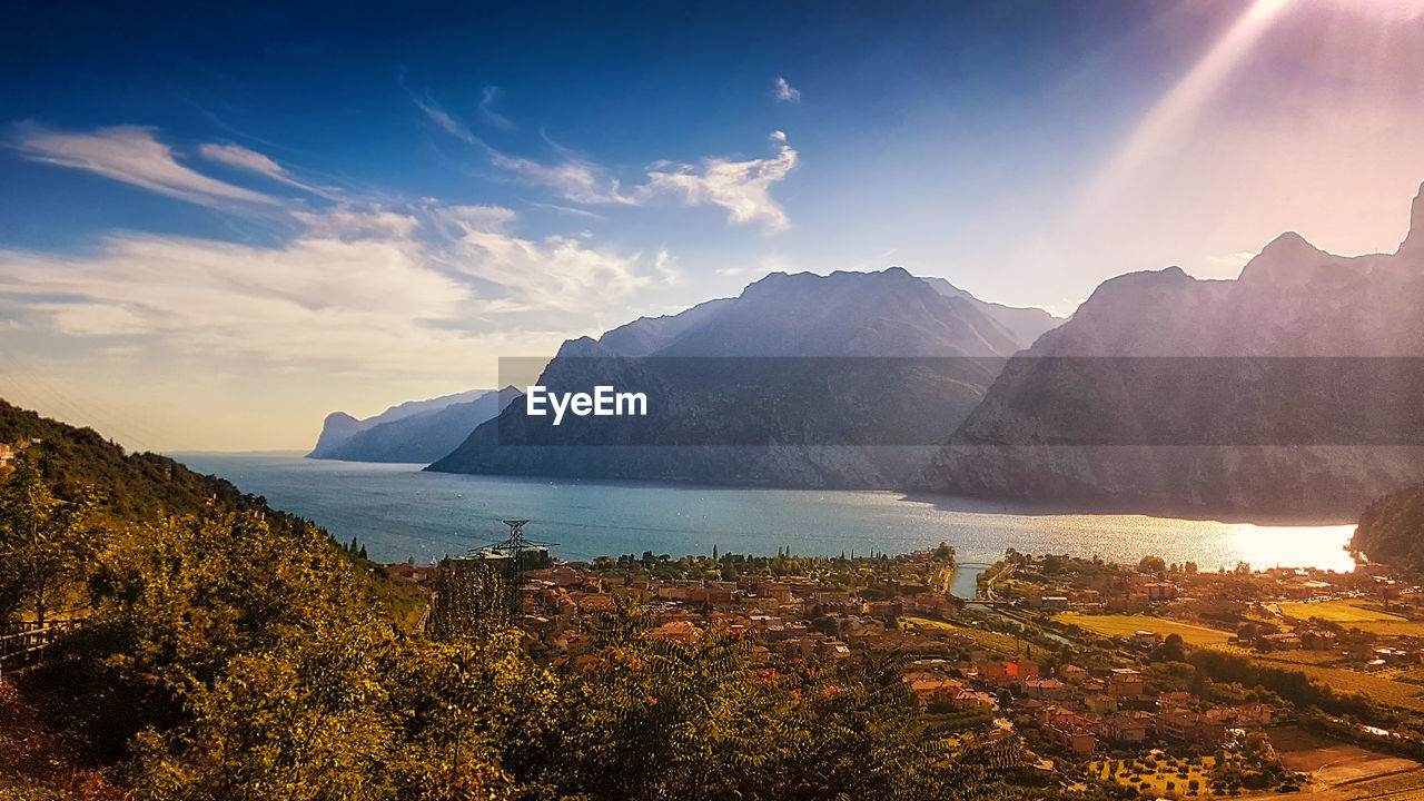 Panoramic view of lake garda against sky during sunset