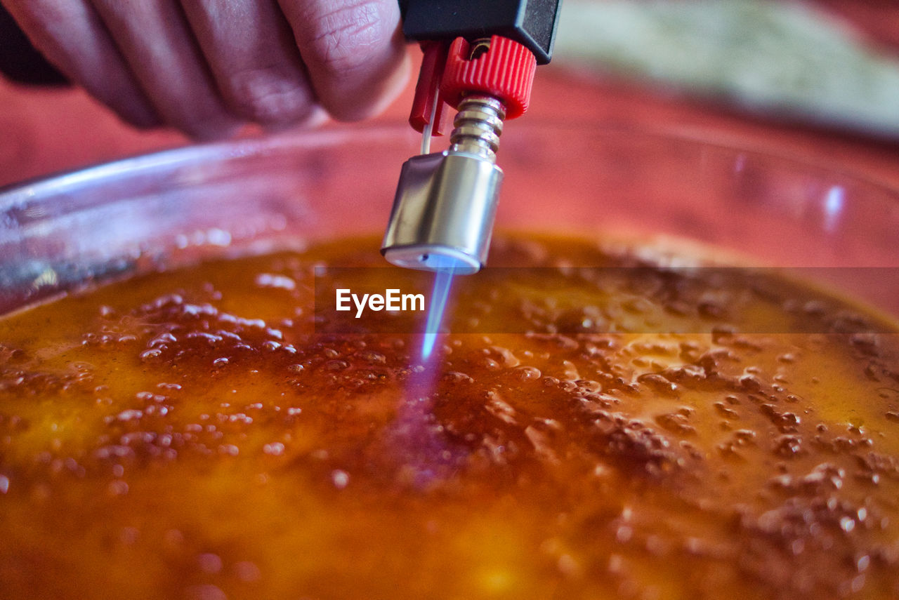 Close-up of person preparing food with burner