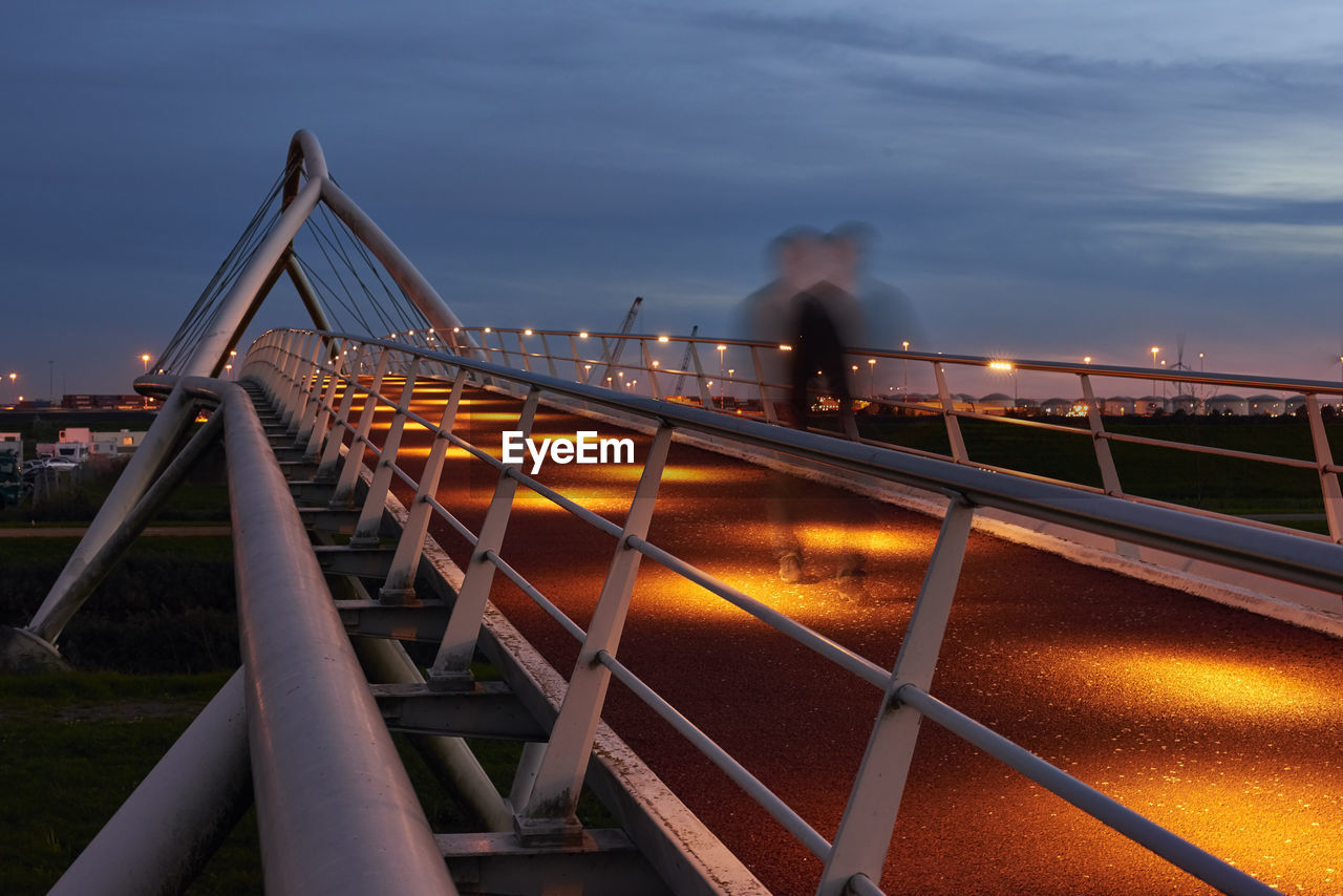 Blurred motion of bridge against sky in blue hour