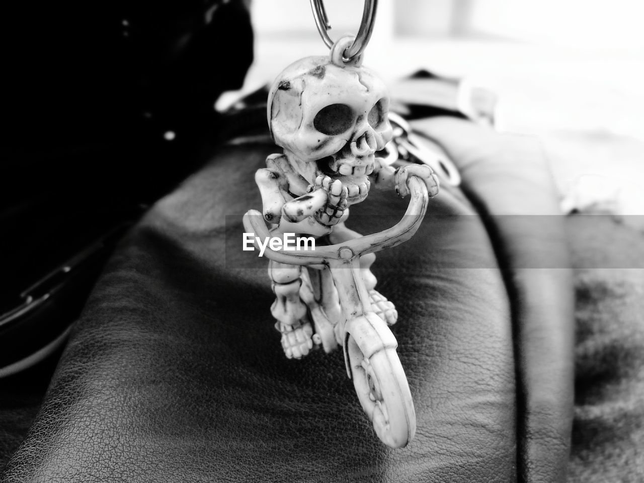 CLOSE-UP OF HUMAN SKULL HANGING FROM METAL