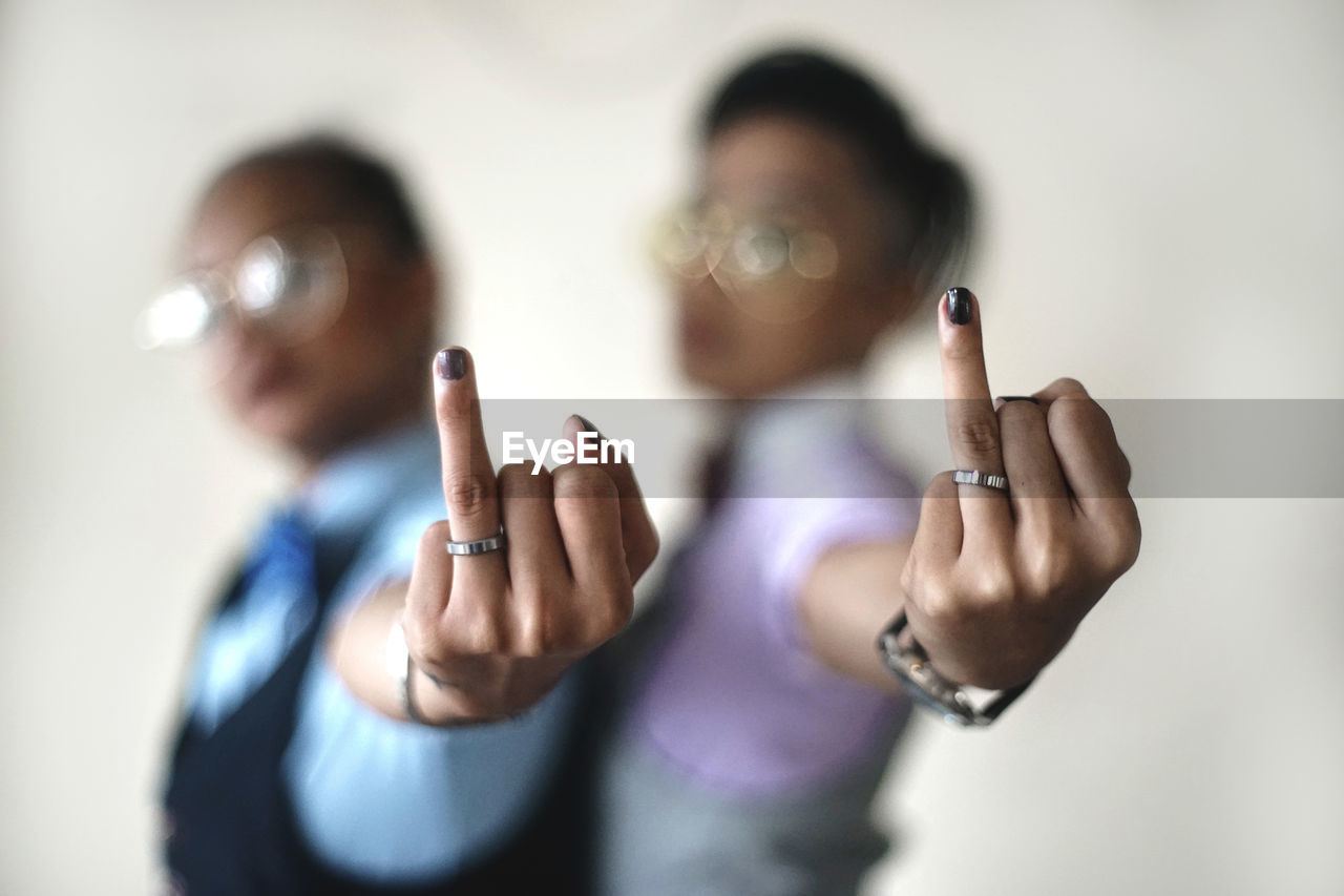 CLOSE-UP OF WOMAN HAND WITH TEXT ON FINGER