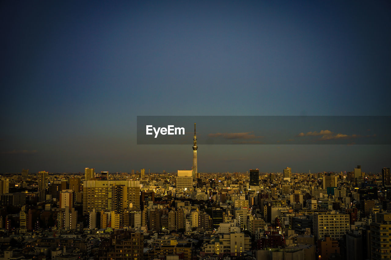 high angle view of illuminated cityscape against sky at night