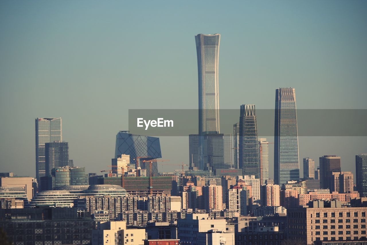 Modern buildings in city against clear sky