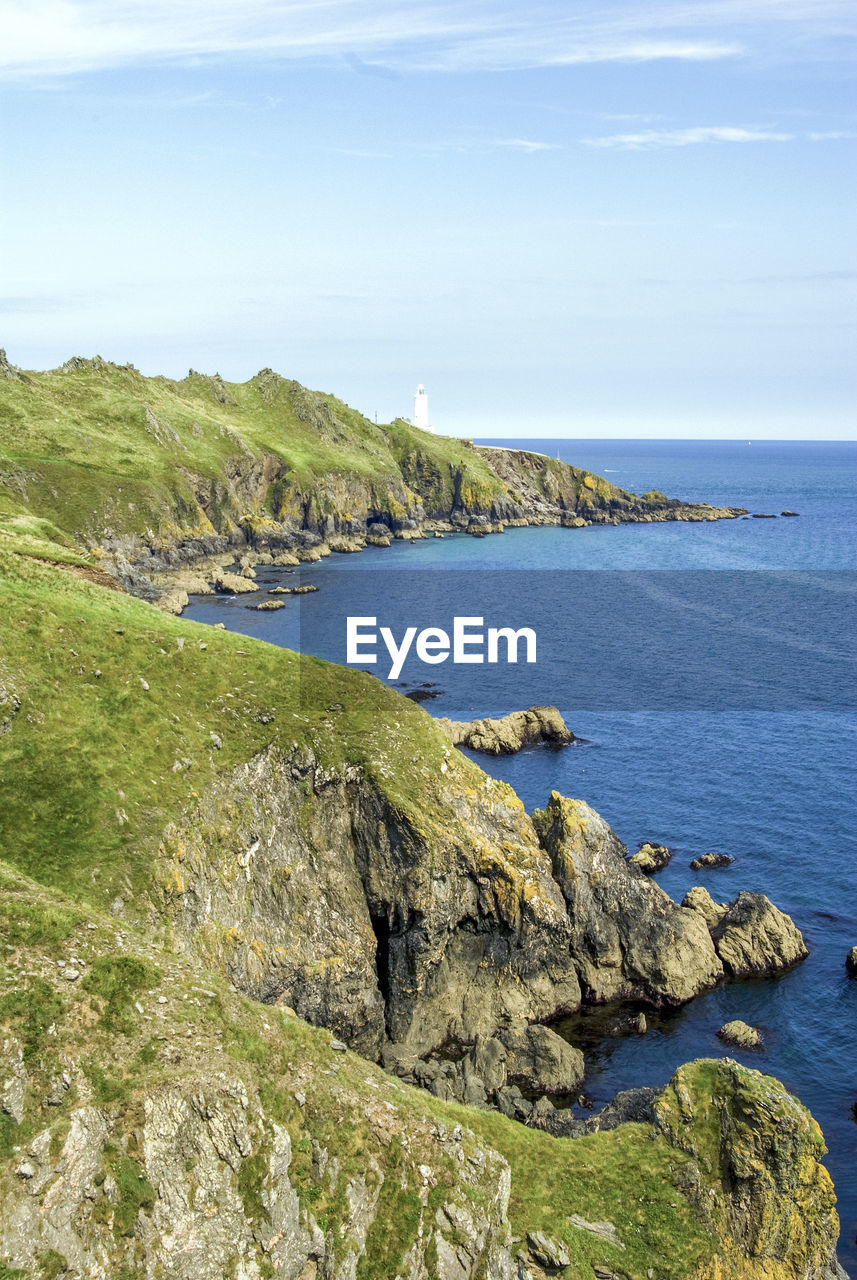 SCENIC VIEW OF SEA AND CLIFF AGAINST SKY