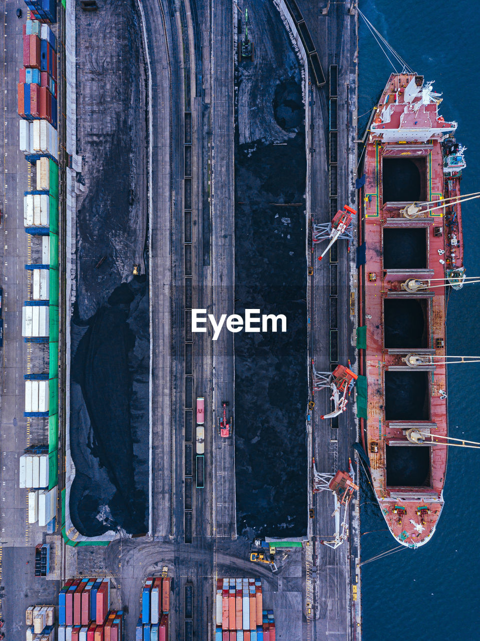 Russia, primorsky krai, vladivostok, aerial view of industrial ship moored in coal loading dock