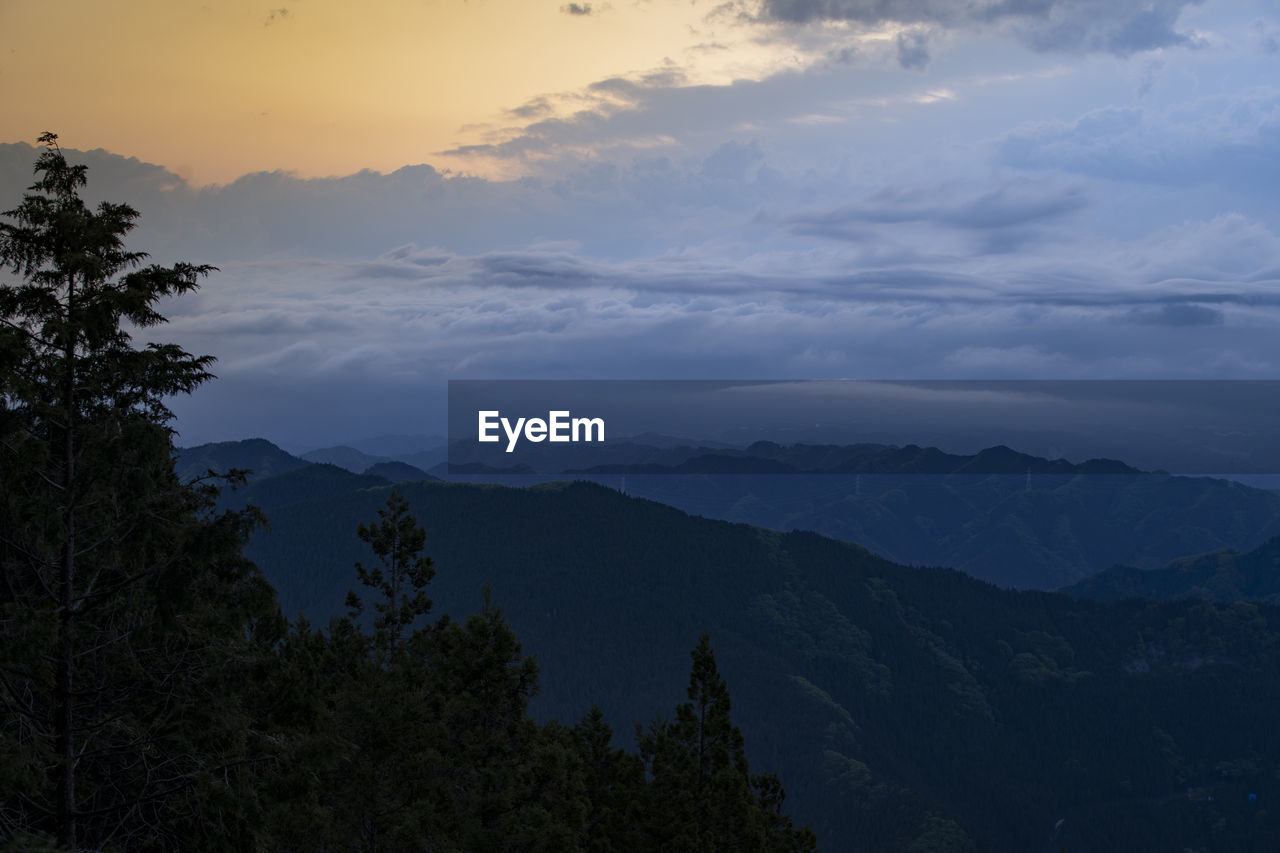 Scenic view of mountains against sky at sunset