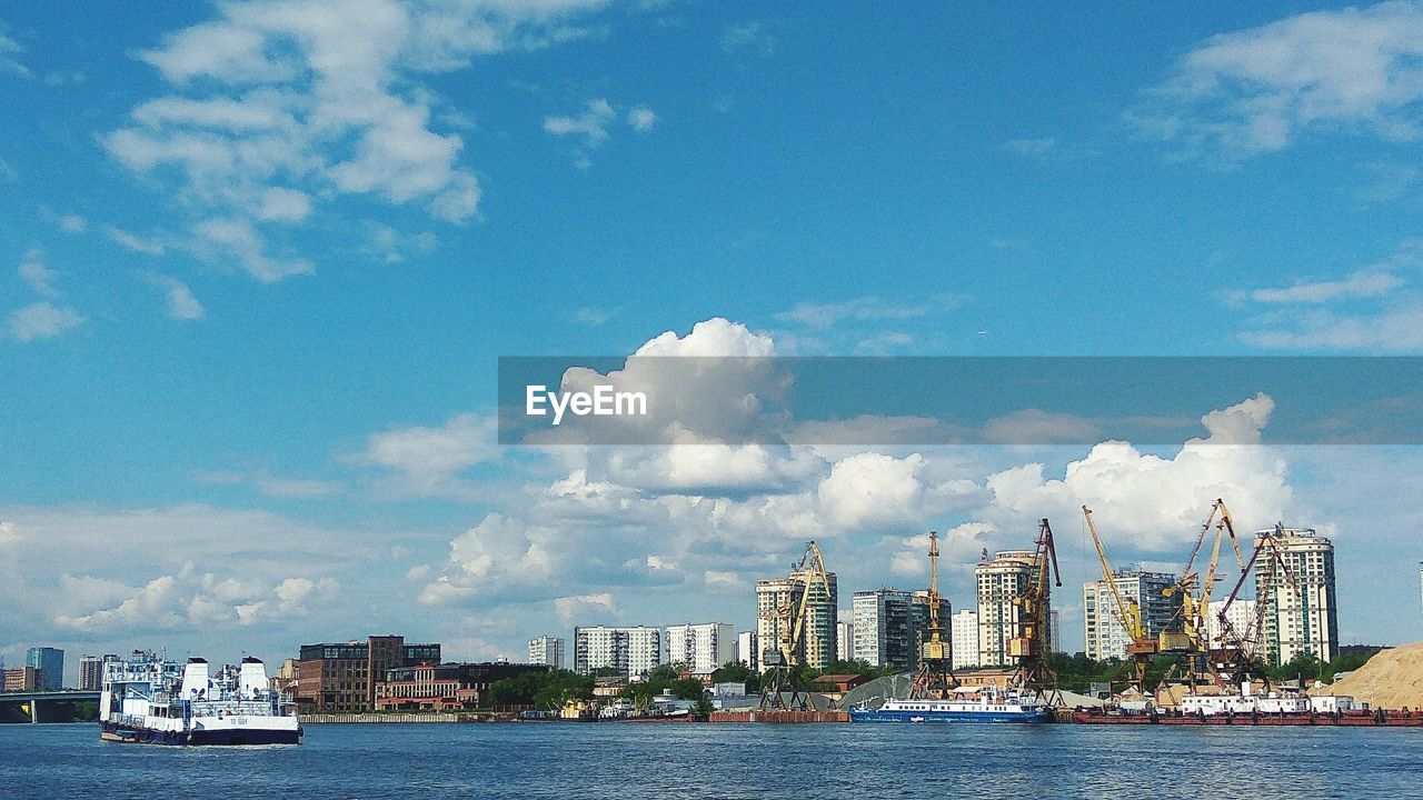 Panoramic view of sea and cityscape against sky