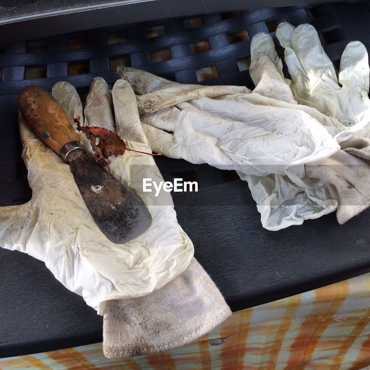 Close-up of dirty gloves and gardening equipment