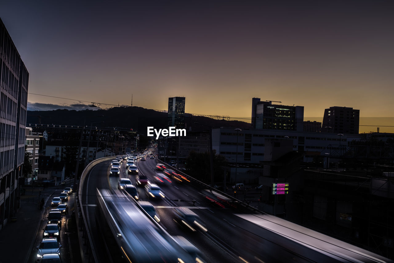 Blurred motion of vehicles on road at sunset