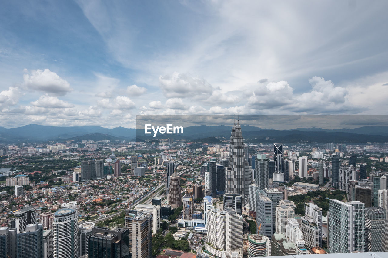 Petronas towers in city seen from menara kuala lumpur tower