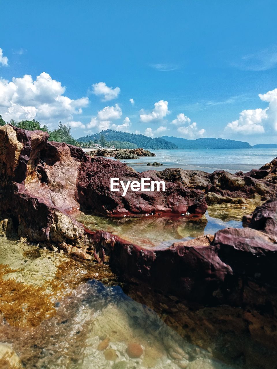 ROCKS ON SHORE AGAINST SKY