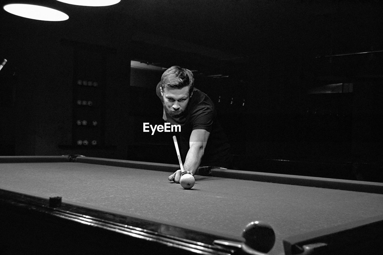 Young man playing snooker