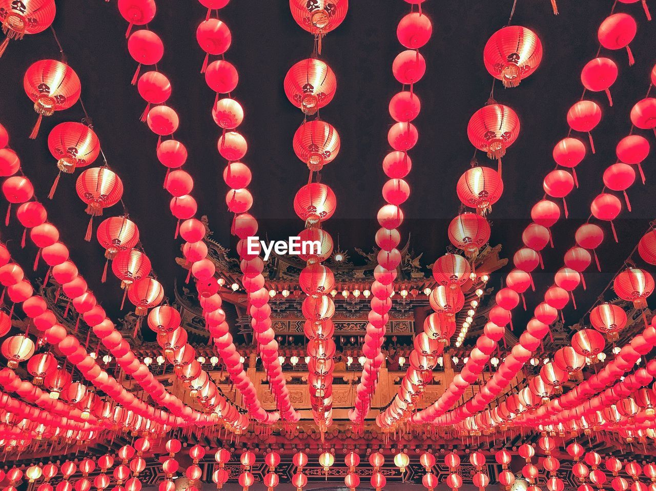 Low angle view of illuminated lanterns hanging at night