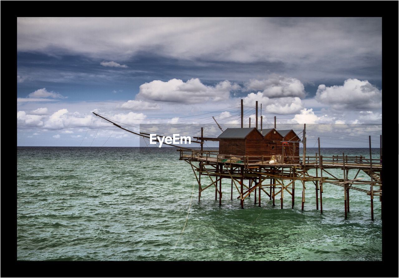 LIFEGUARD HUT AT BEACH AGAINST SKY