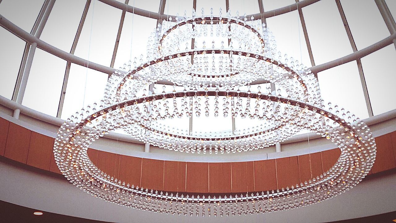 Low angle view of chandelier in modern building