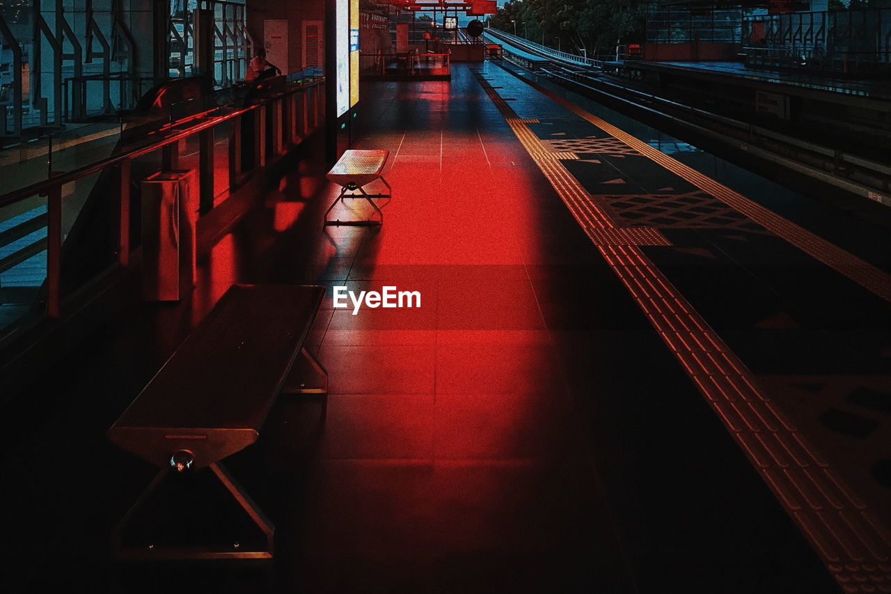 Empty benches on railroad platform at night