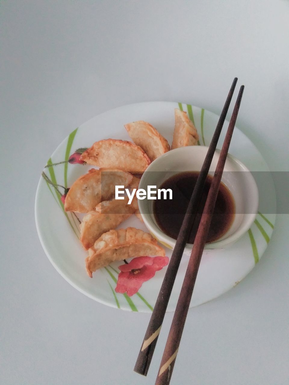 food and drink, food, chopsticks, healthy eating, freshness, plate, asian food, studio shot, indoors, dish, wellbeing, no people, cuisine, meat, high angle view, seafood, sauce, meal, fast food, gray background, bowl, still life, condiment, chinese food, vegetable, savory food, table, appetizer