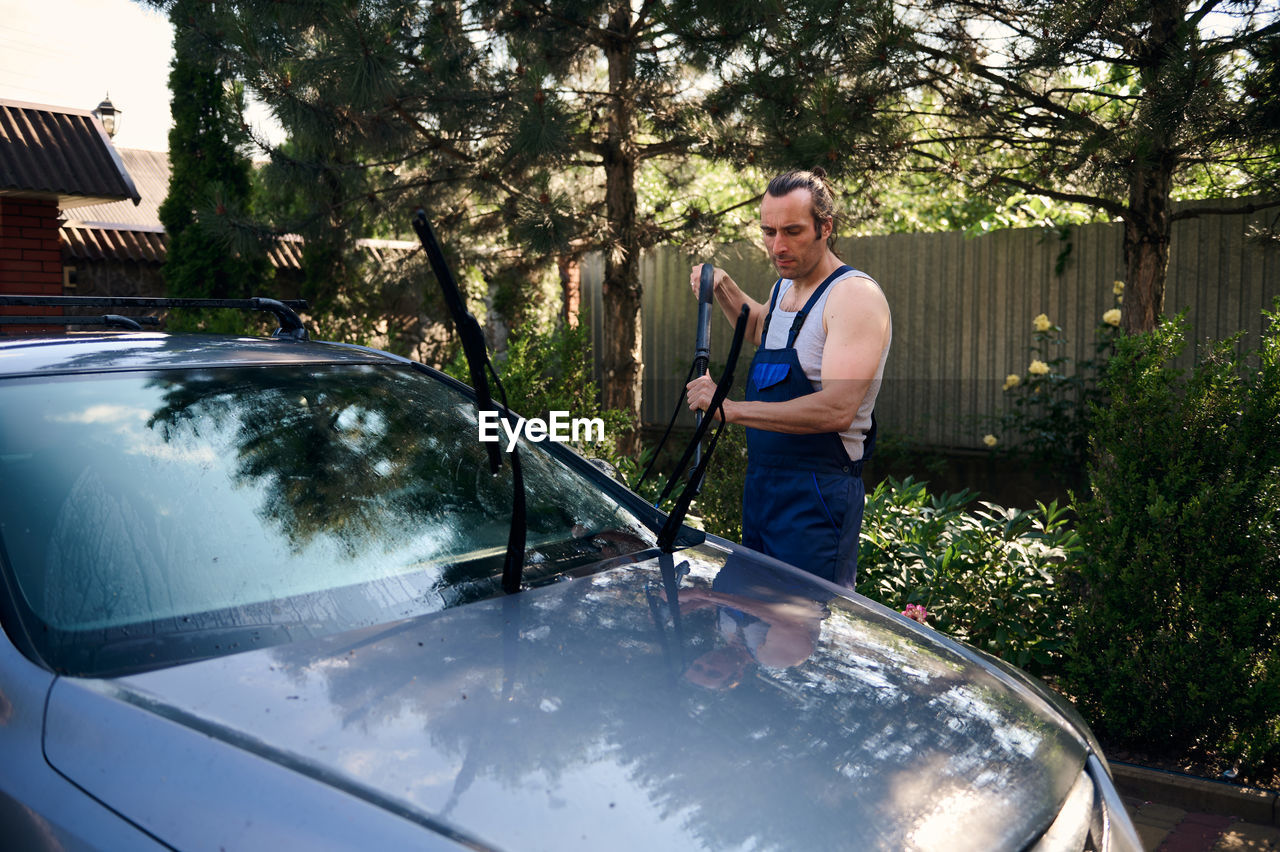 low angle view of man sitting in car