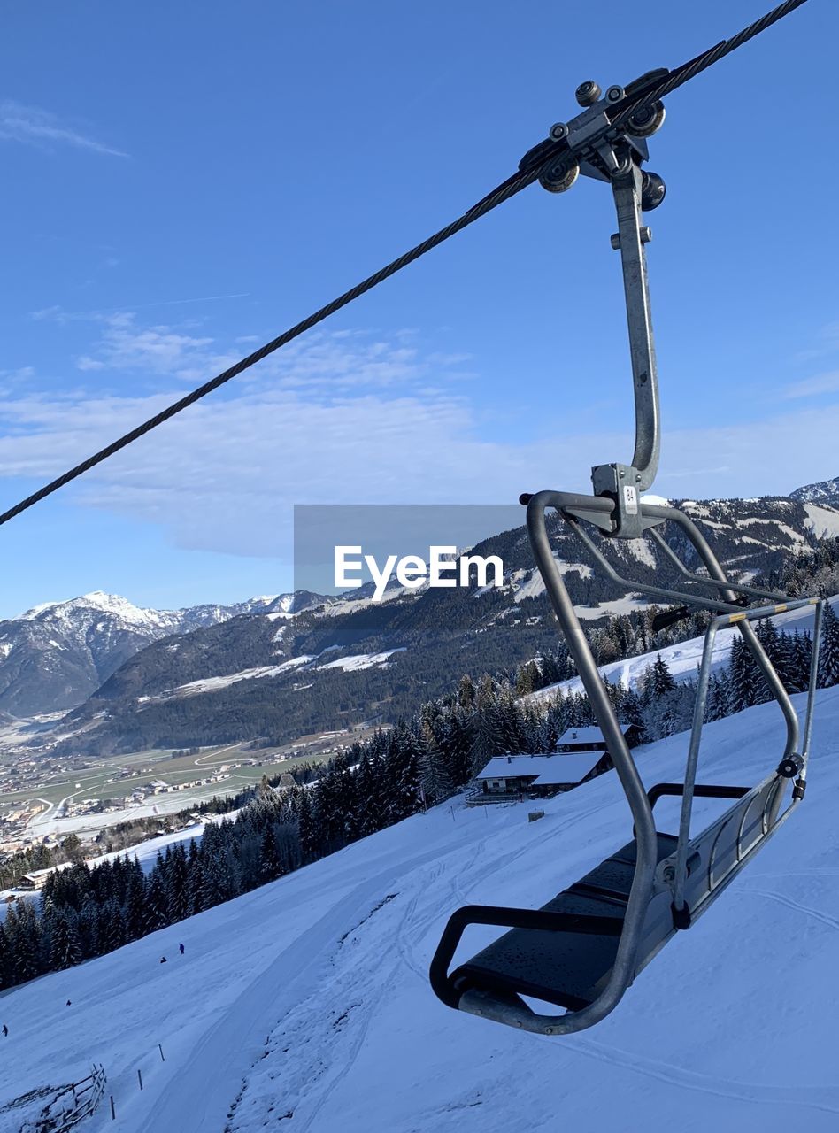 OVERHEAD CABLE CAR AGAINST SNOWCAPPED MOUNTAINS
