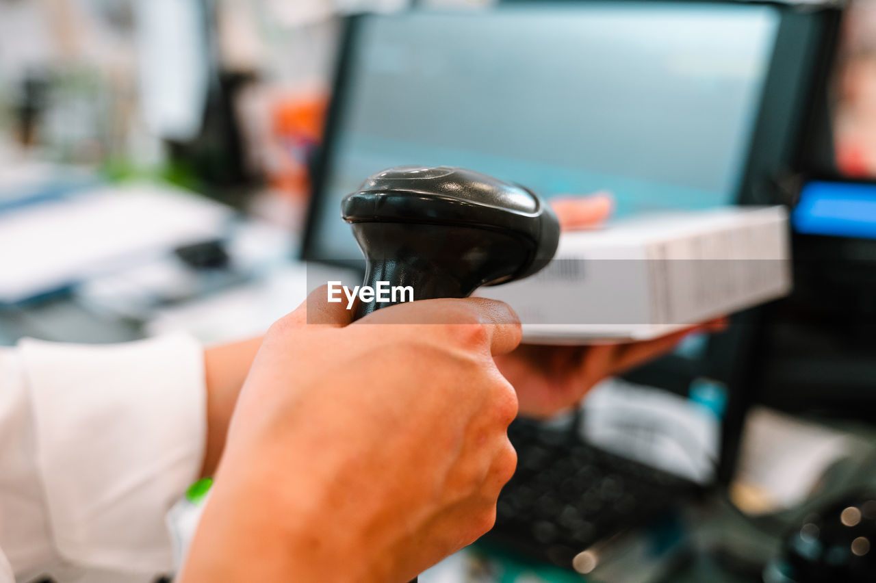 cropped hand of man holding equipment