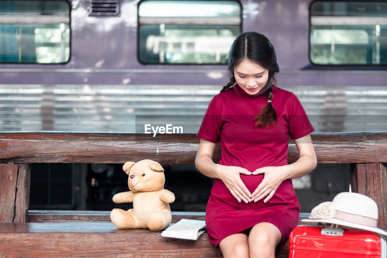 portrait of young woman sitting in train