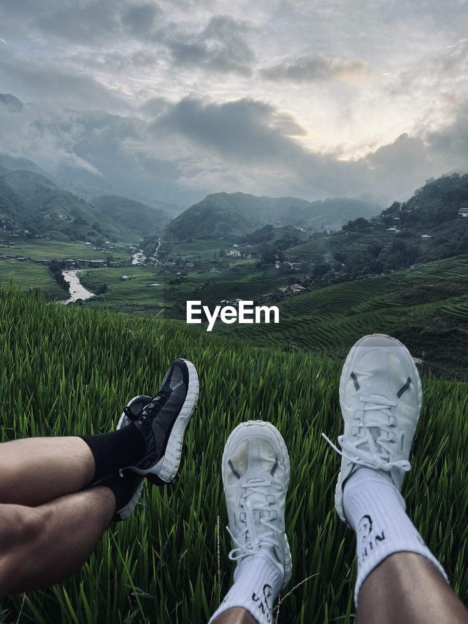personal perspective, mountain, human leg, nature, grass, shoe, low section, landscape, environment, scenics - nature, sky, leisure activity, plant, limb, land, human limb, beauty in nature, mountain range, adult, cloud, lifestyles, footwear, green, one person, field, relaxation, hiking, human foot, outdoors, activity, men, day, tranquility, rural scene, meadow, walking shoe, holiday, tranquil scene, non-urban scene, vacation, plain, travel, trip, women, adventure, valley