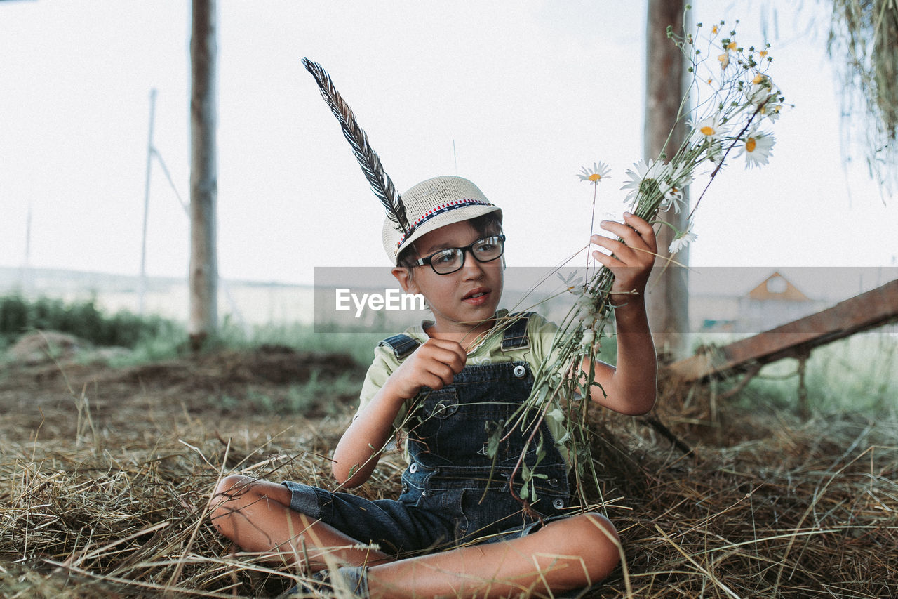 Full length of boy sitting on grass