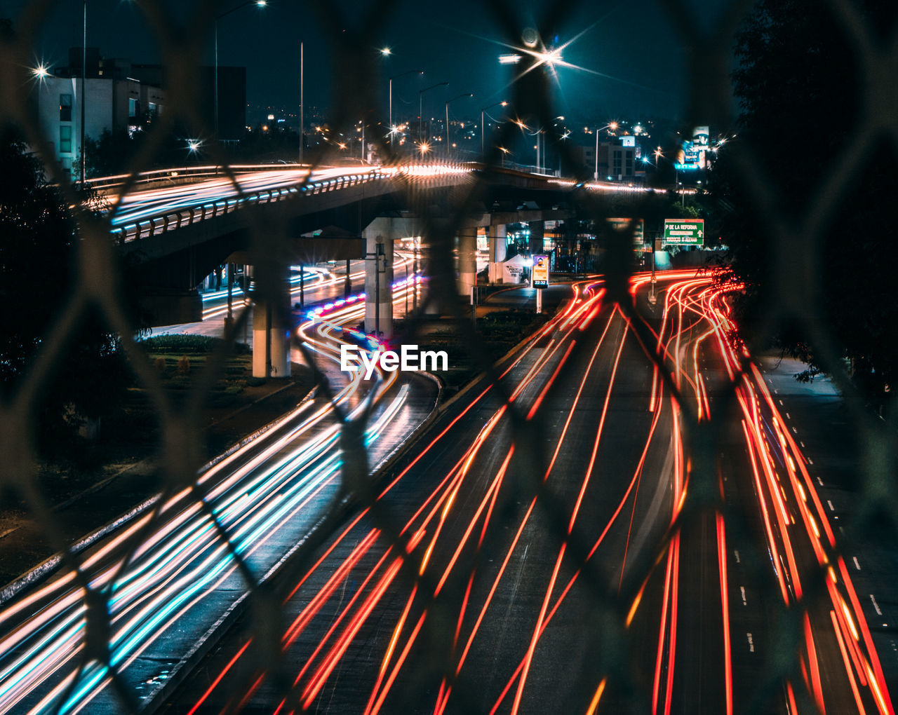 HIGH ANGLE VIEW OF LIGHT TRAILS ON ROAD