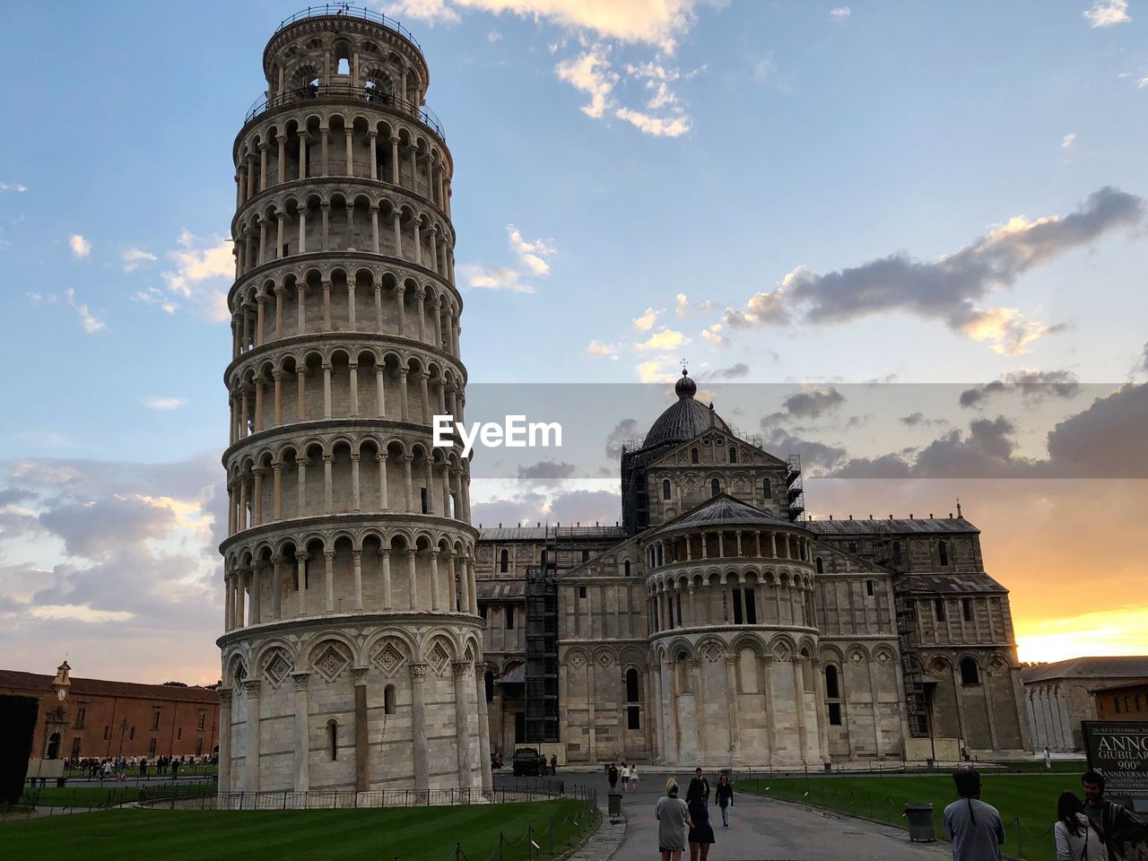 Low angle view of leaning tower of pisa against sky during sunset