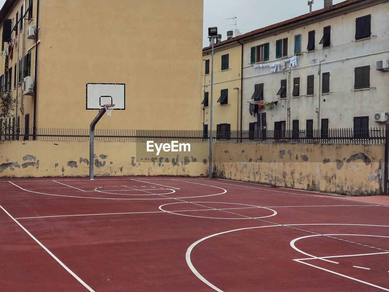 Basketball hoop by buildings in city