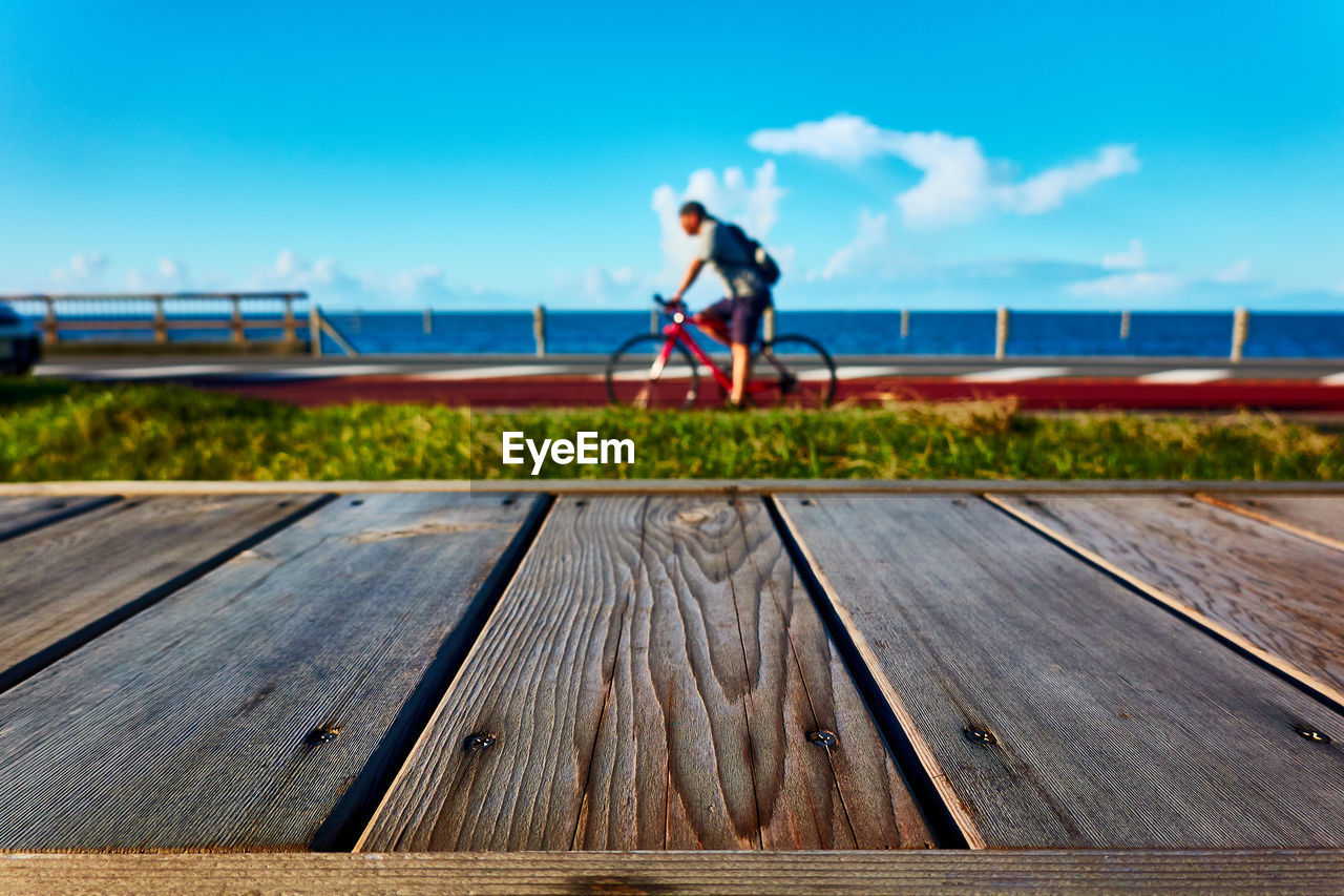 MAN WITH BICYCLE ON PIER