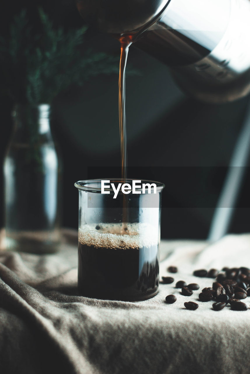 CLOSE-UP OF COFFEE POURING IN GLASS