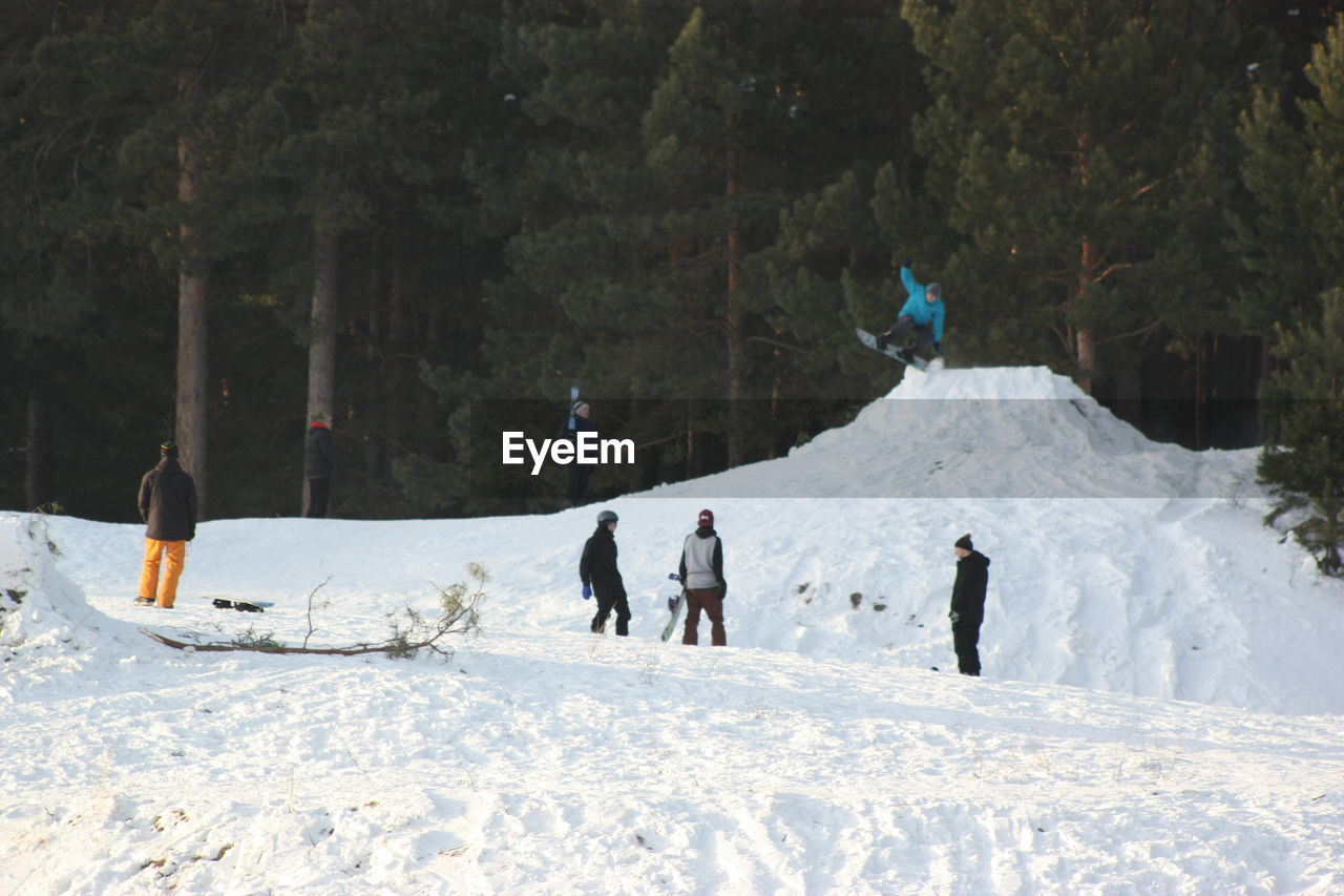 PEOPLE ON SNOW COVERED LANDSCAPE