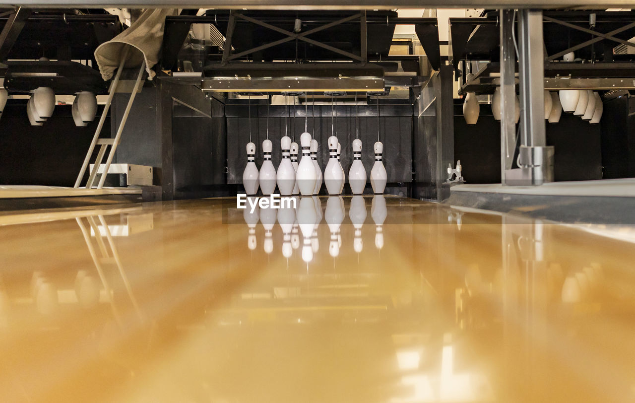 Bowling pins arranged on track at alley