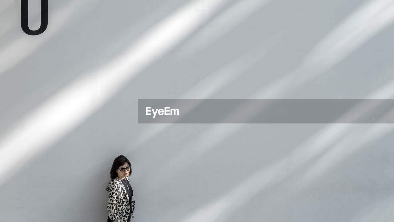 Woman standing against wall