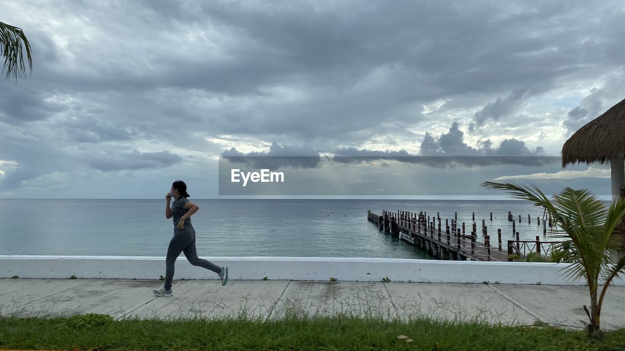 Man looking at sea against sky