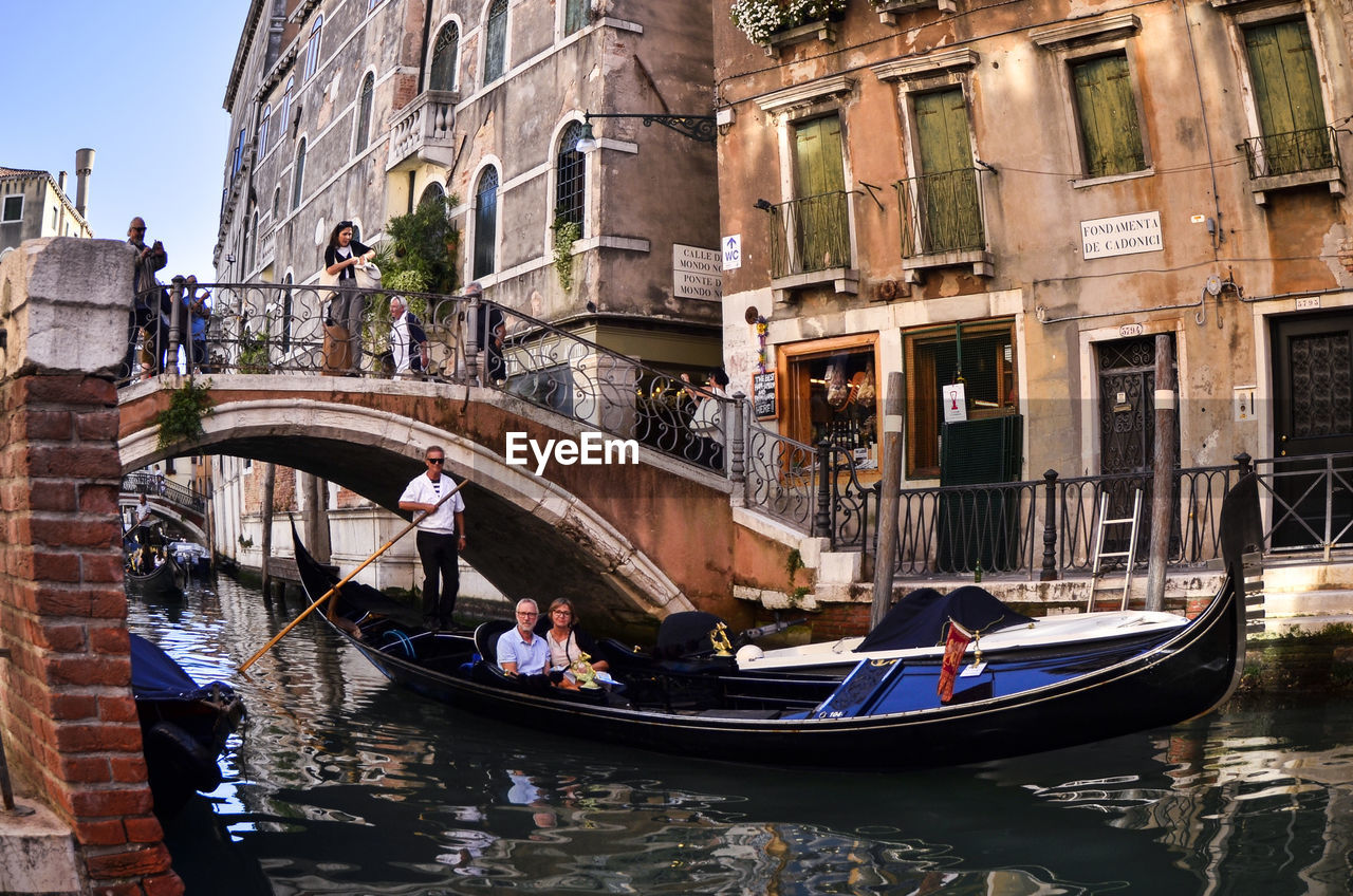 PEOPLE IN BOAT IN CANAL